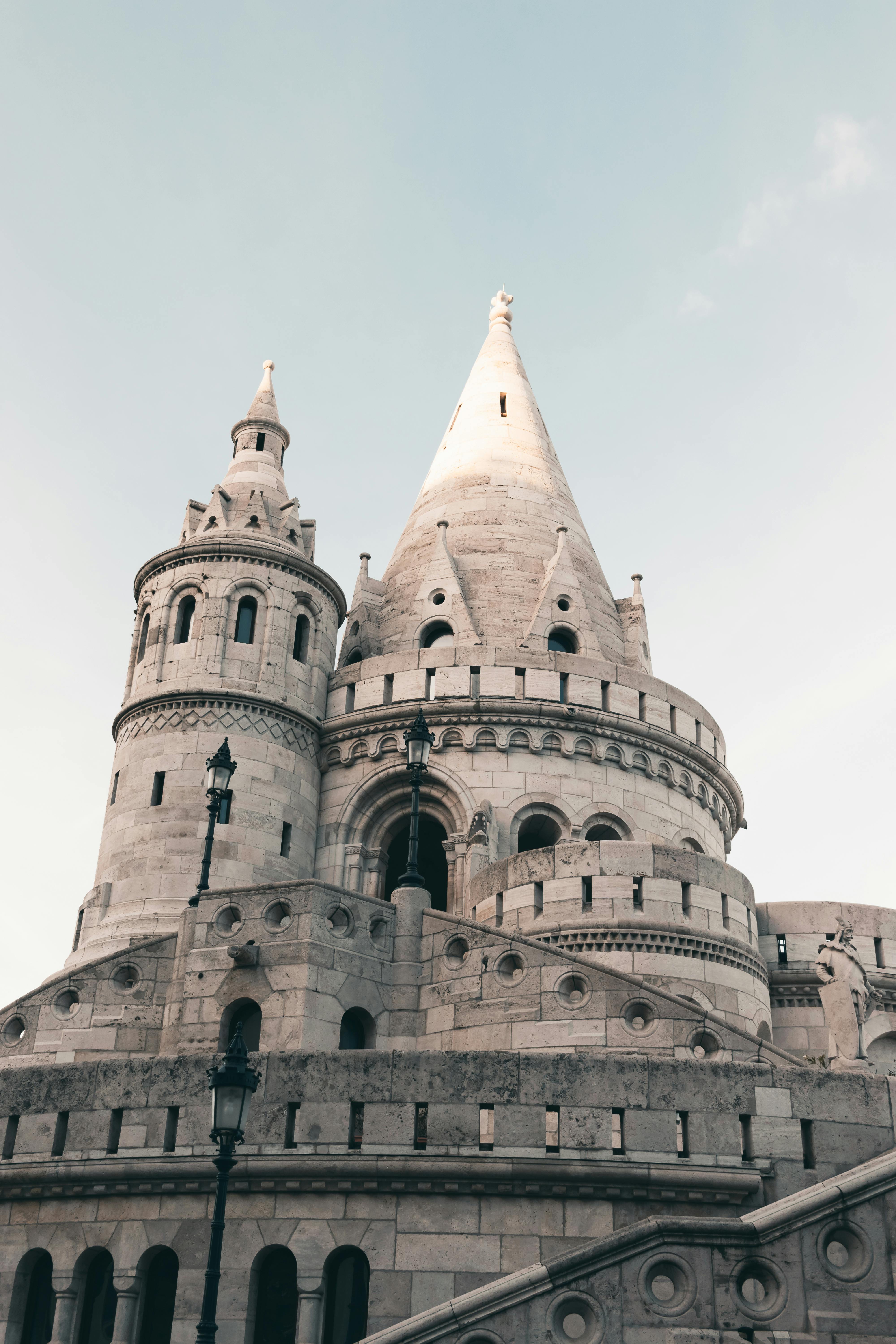 Stunning view of Fisherman's Bastion towers in Budapest, Hungary, captured from below against a clear sky.