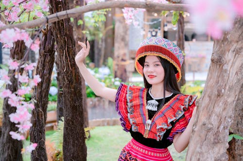 Free A woman in traditional clothing posing in front of a tree Stock Photo