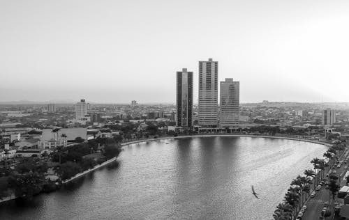 A black and white photo of a city with a river