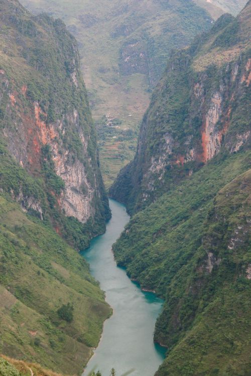 Free A breathtaking aerial view of a lush canyon river in Ha Giang, Vietnam, with dramatic cliffs. Stock Photo