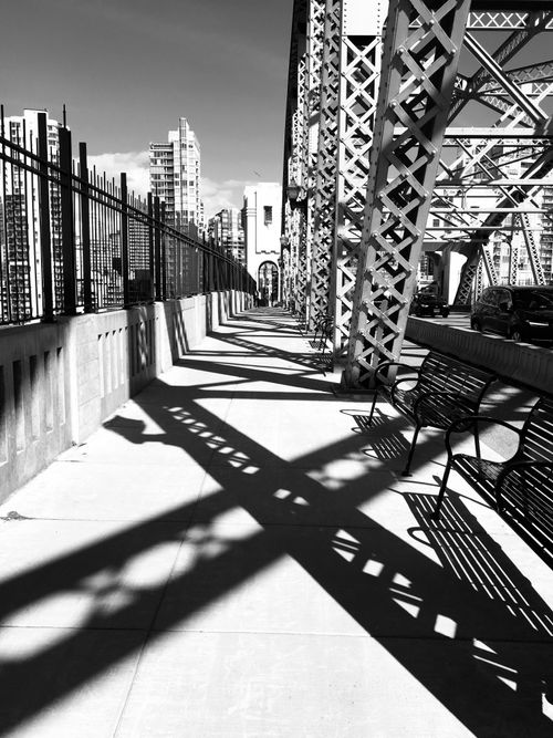 Free Artistic black and white photo of a bridge in Vancouver, featuring strong shadows and urban architecture. Stock Photo