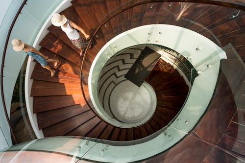 Free Two People Walking On Spiral Stairs Stock Photo