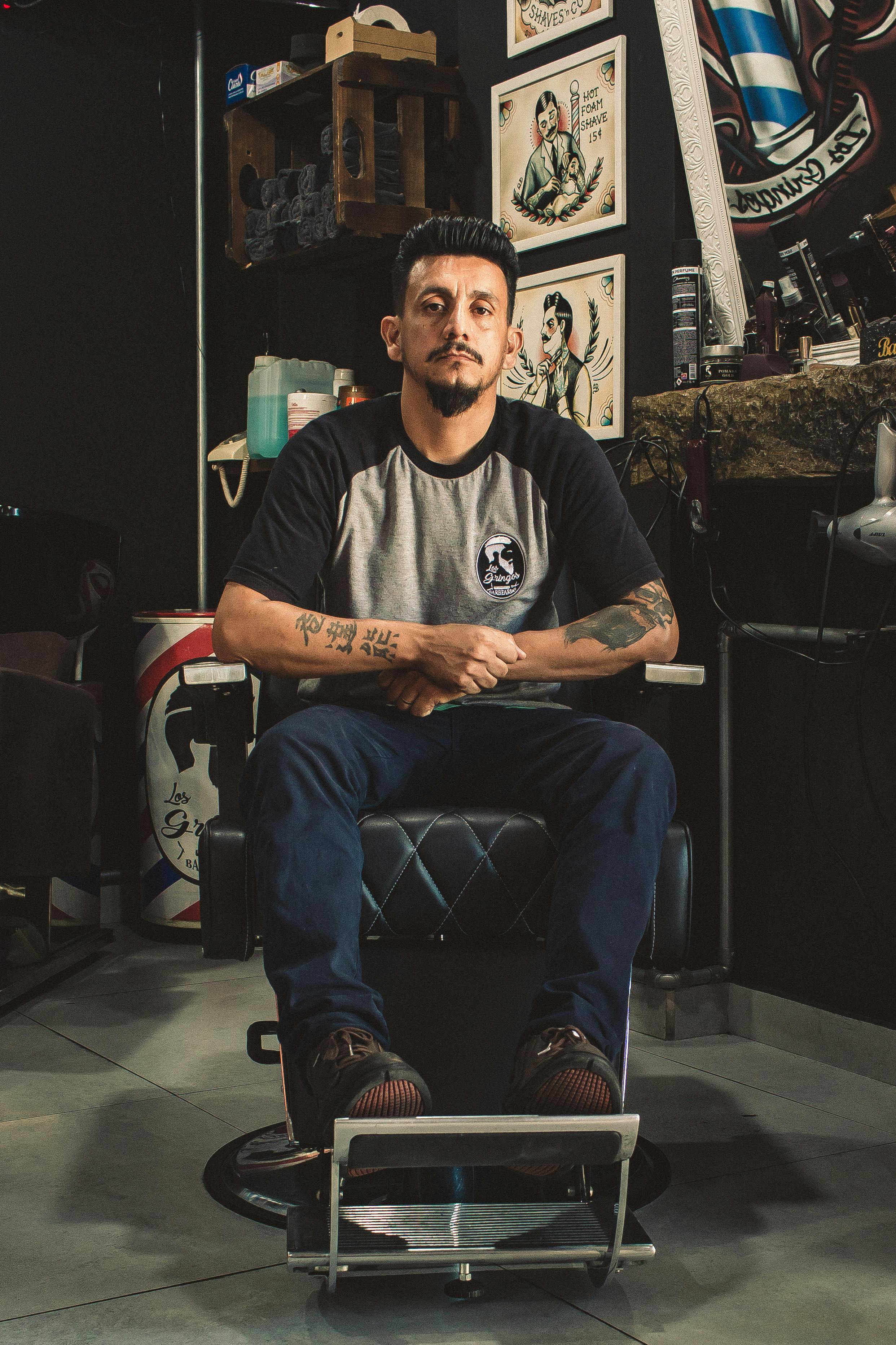 Man Sitting On Barber Chair Inside Room