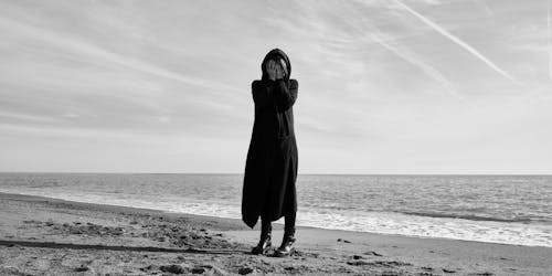 Free Woman Standing at the Beach Stock Photo