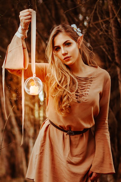 Free Woman Wearing Brown Long-sleeved Shirt Holding Round Glass Terrarium Stock Photo