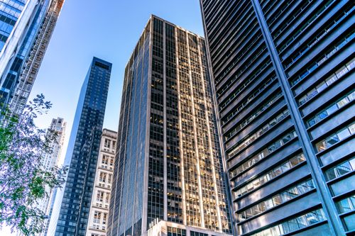 Free High-rise buildings in New York City's urban skyline under clear blue sky. Stock Photo