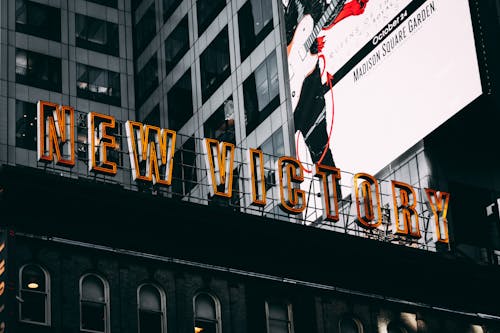 Low-angle Photography of New Victory Sign Below Madison Square Garden Billboard