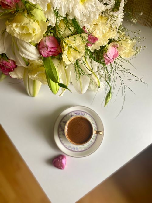Free Delightful floral bouquet with a cup of Turkish coffee, showcasing elegance and taste. Stock Photo