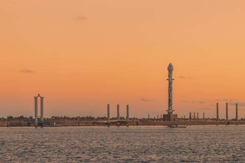 A tower in the distance with a sunset in the background