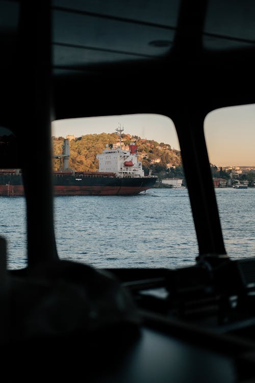 Sailing Cargo Ship behind Window