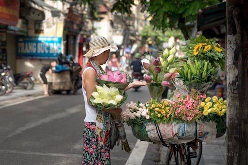 Woman Selling Flowers on Roadside