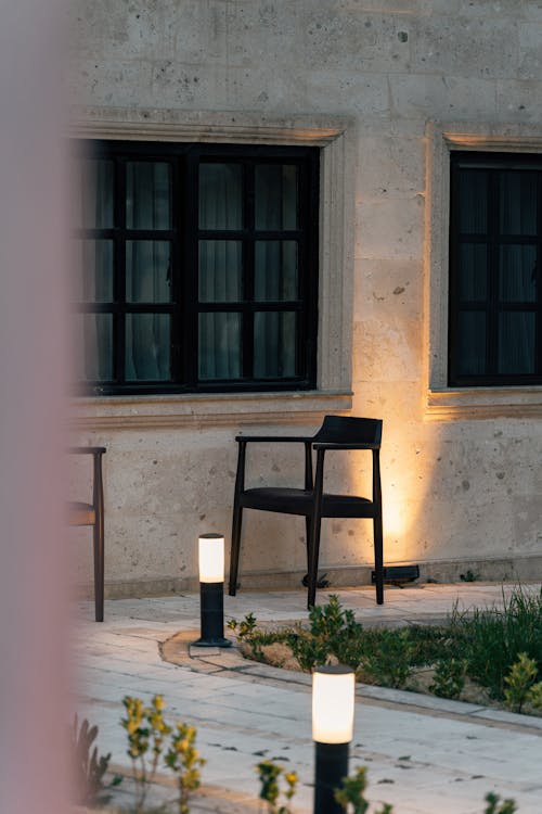 Two chairs and a lamp on a patio