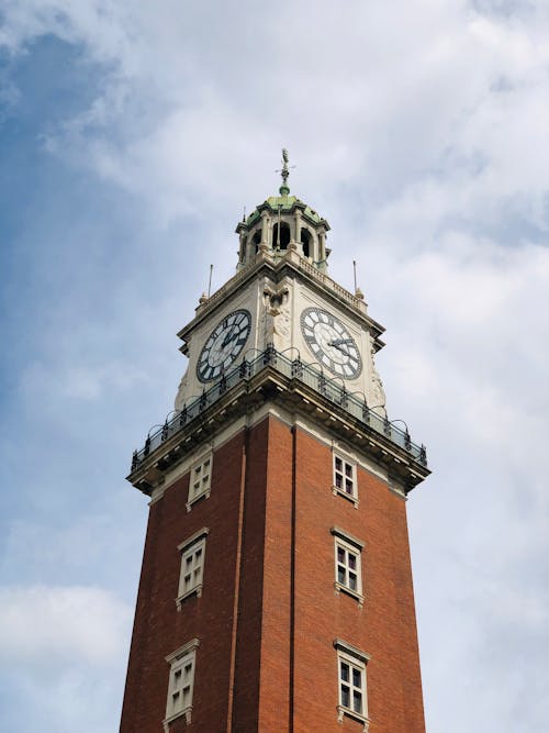 A tall brick tower with a clock on top