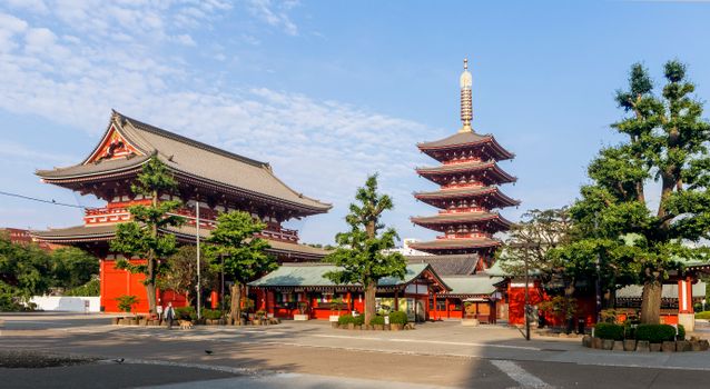 Sunny view of Senso-ji Temple and Five-Storied Pagoda in Tokyo, showcasing traditional Japanese architecture.