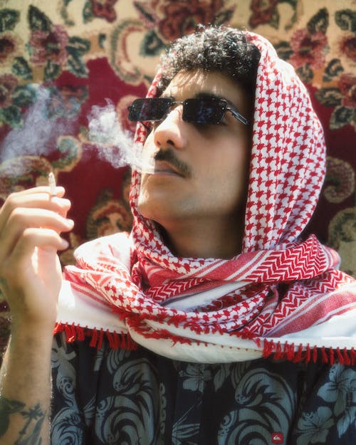 Man in Shawl Smoking Cigarette