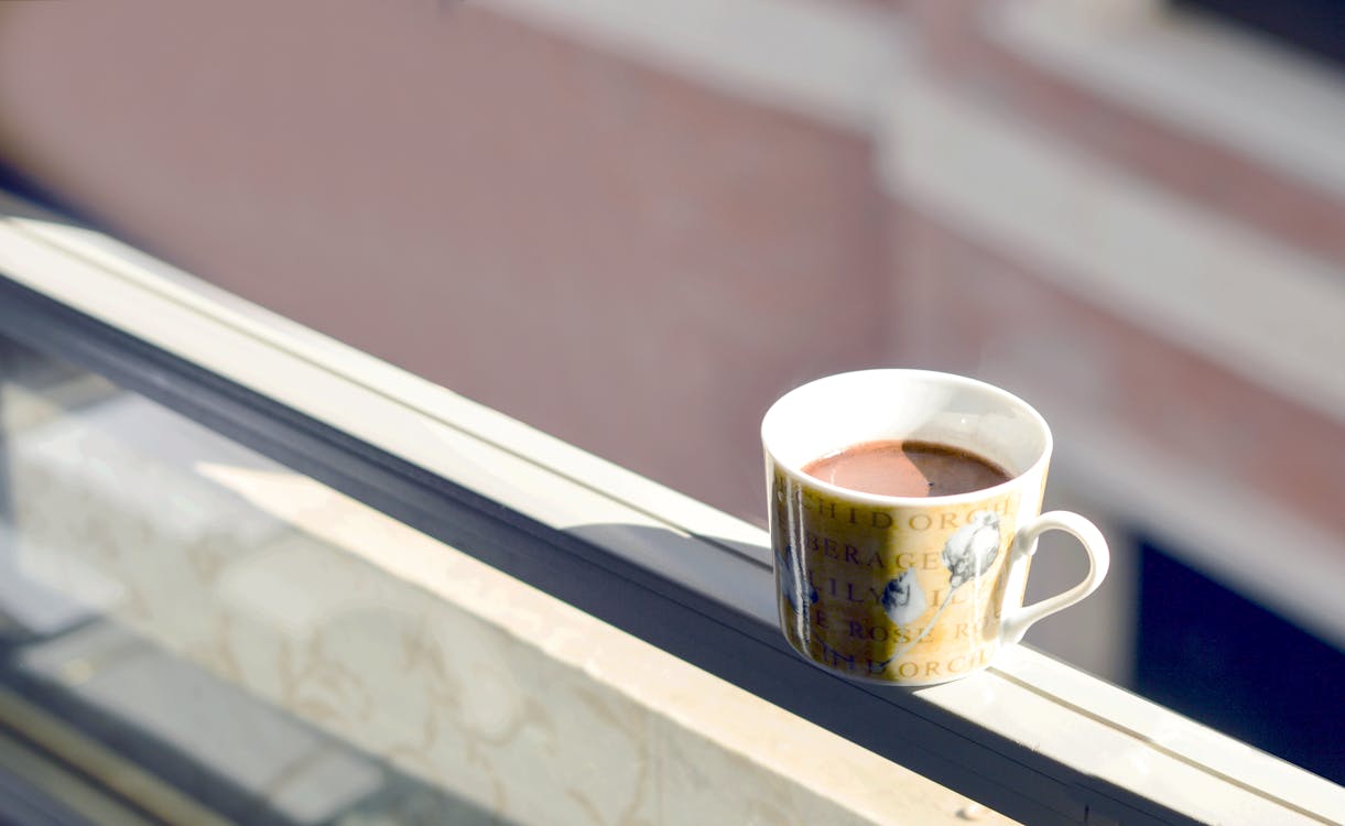 Free Coffee in White and Yellow Ceramic Mug on White Surface Stock Photo