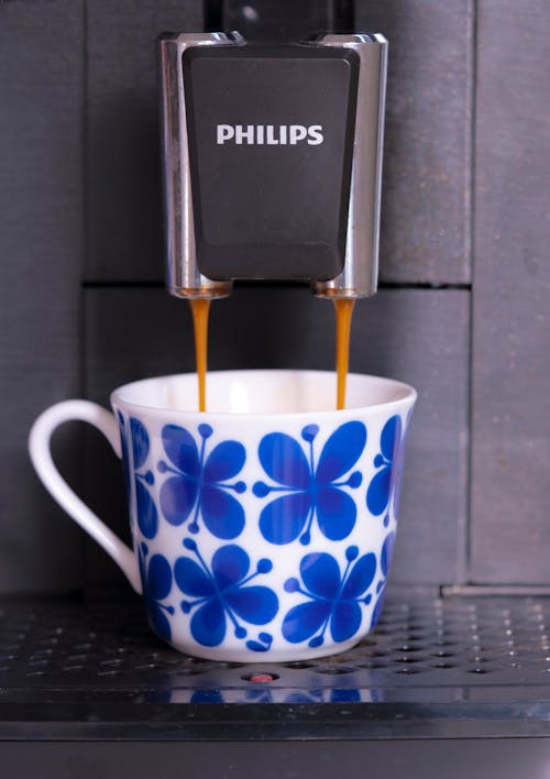 A coffee cup with a blue flower on it