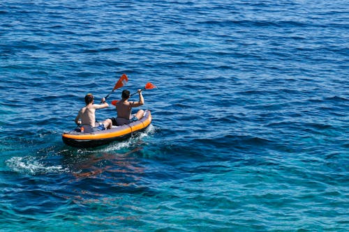 Duo Kayaking on the Vast Blue Sea