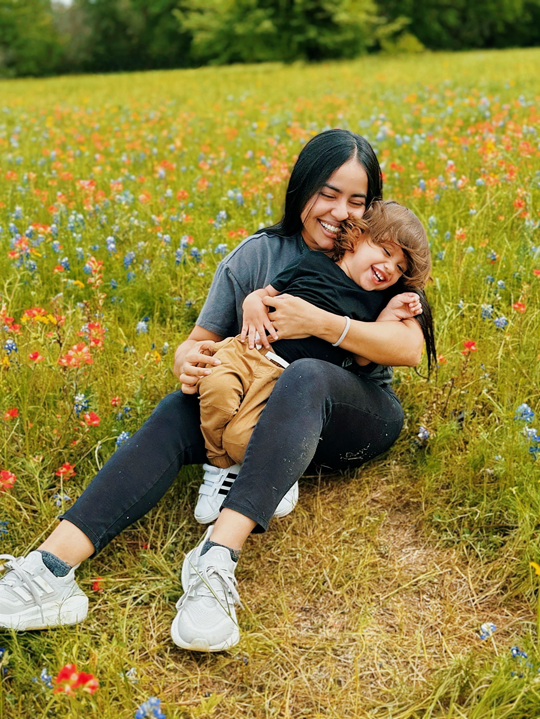 Mother and Son Sitting in Front of a Meadow · Free Stock Photo