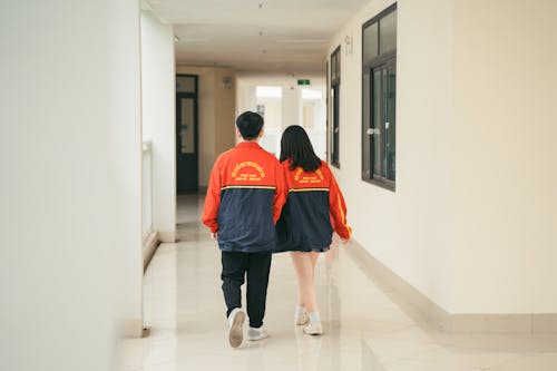 Back View of Couple Walking in Corridor