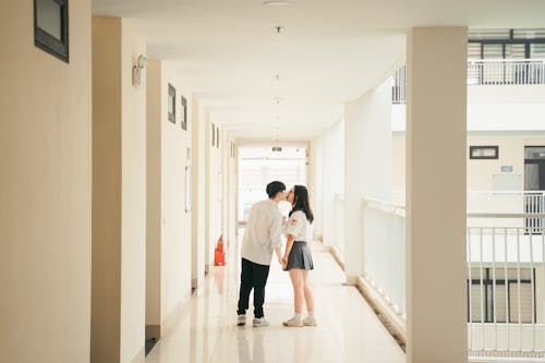 Couple Kissing in Corridor
