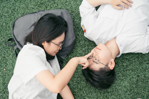 Woman Lying Down with Man and Touching Nose