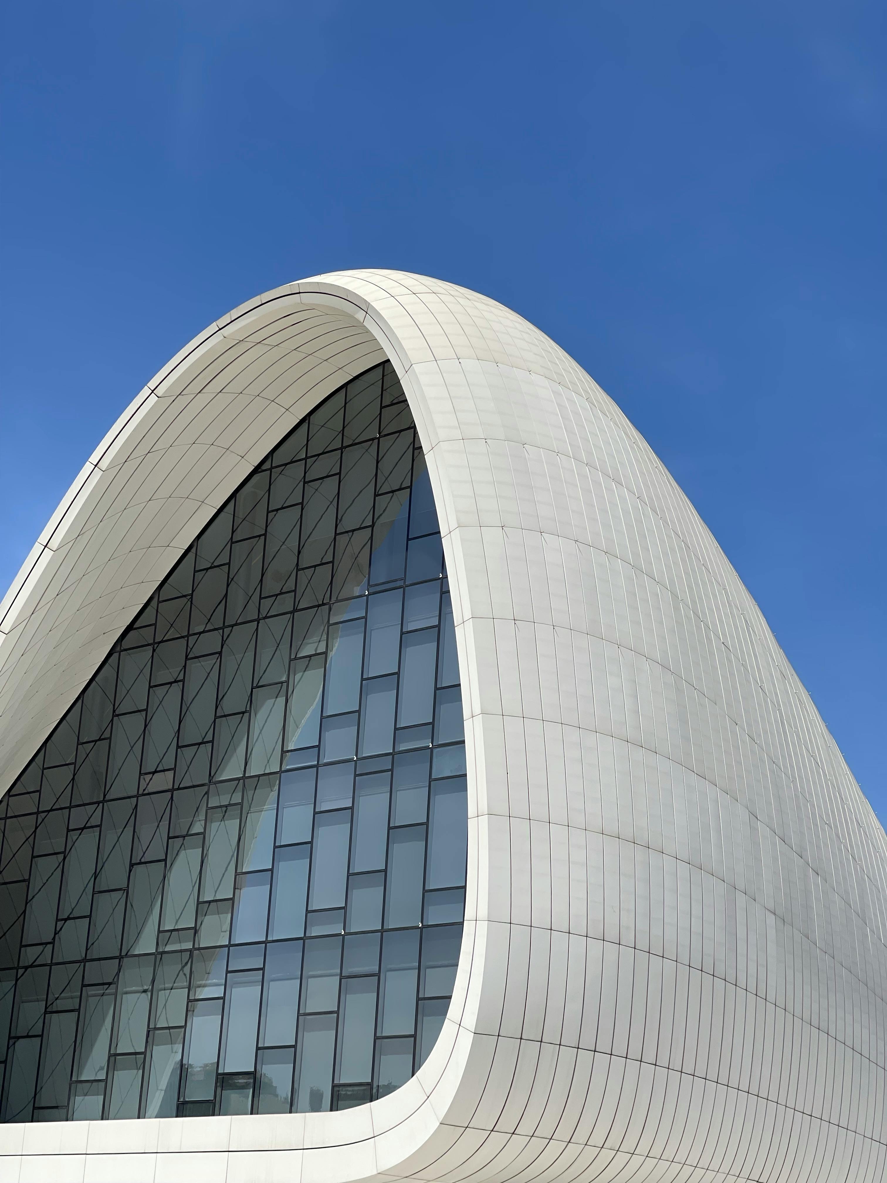Discover the iconic modern architecture of the Heydar Aliyev Center in Baku, featuring sleek, curved design and glass facade.