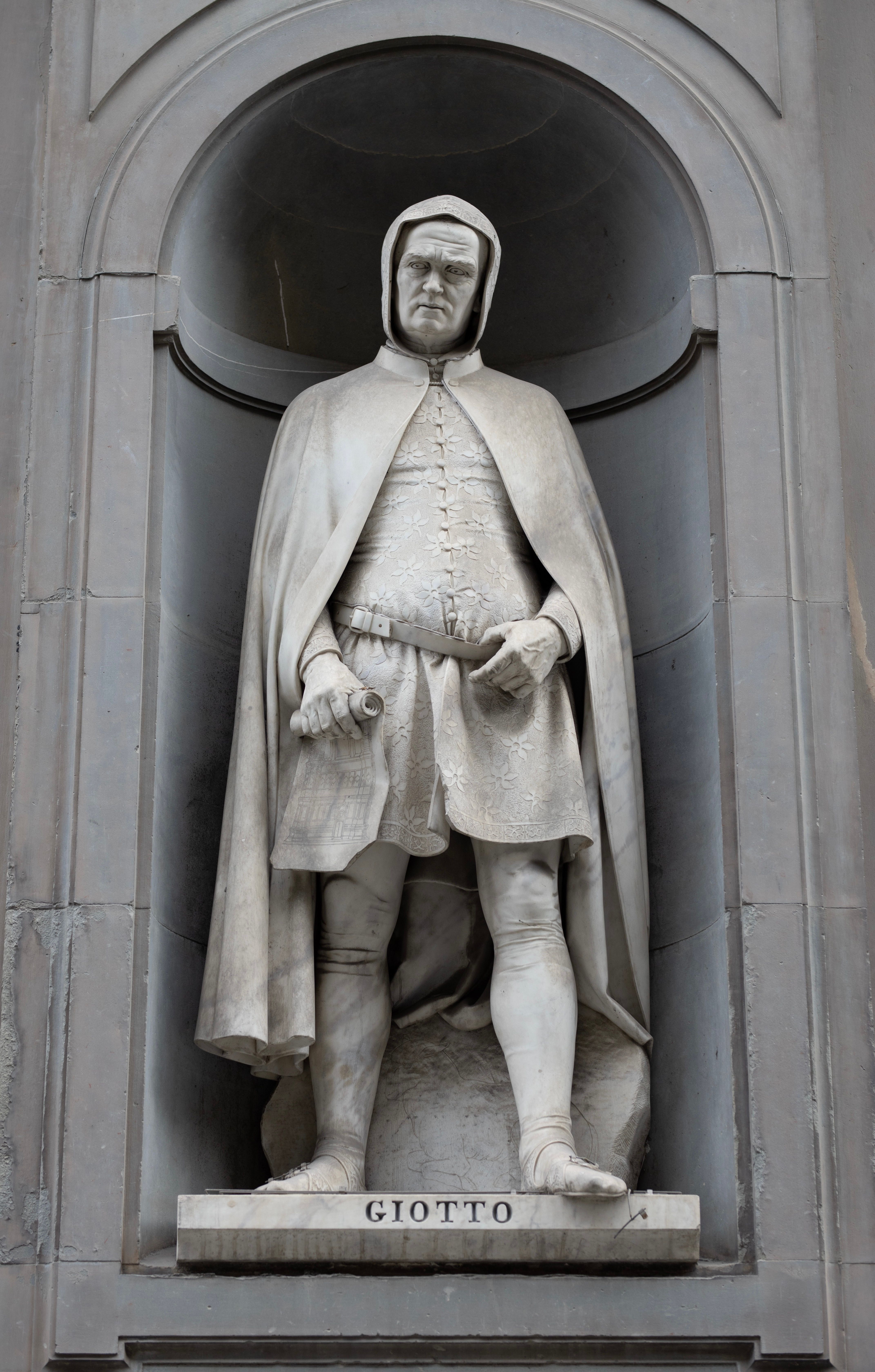 Statue of Giotto di Bondone set in an ornate niche, Tuscany, Italy.
