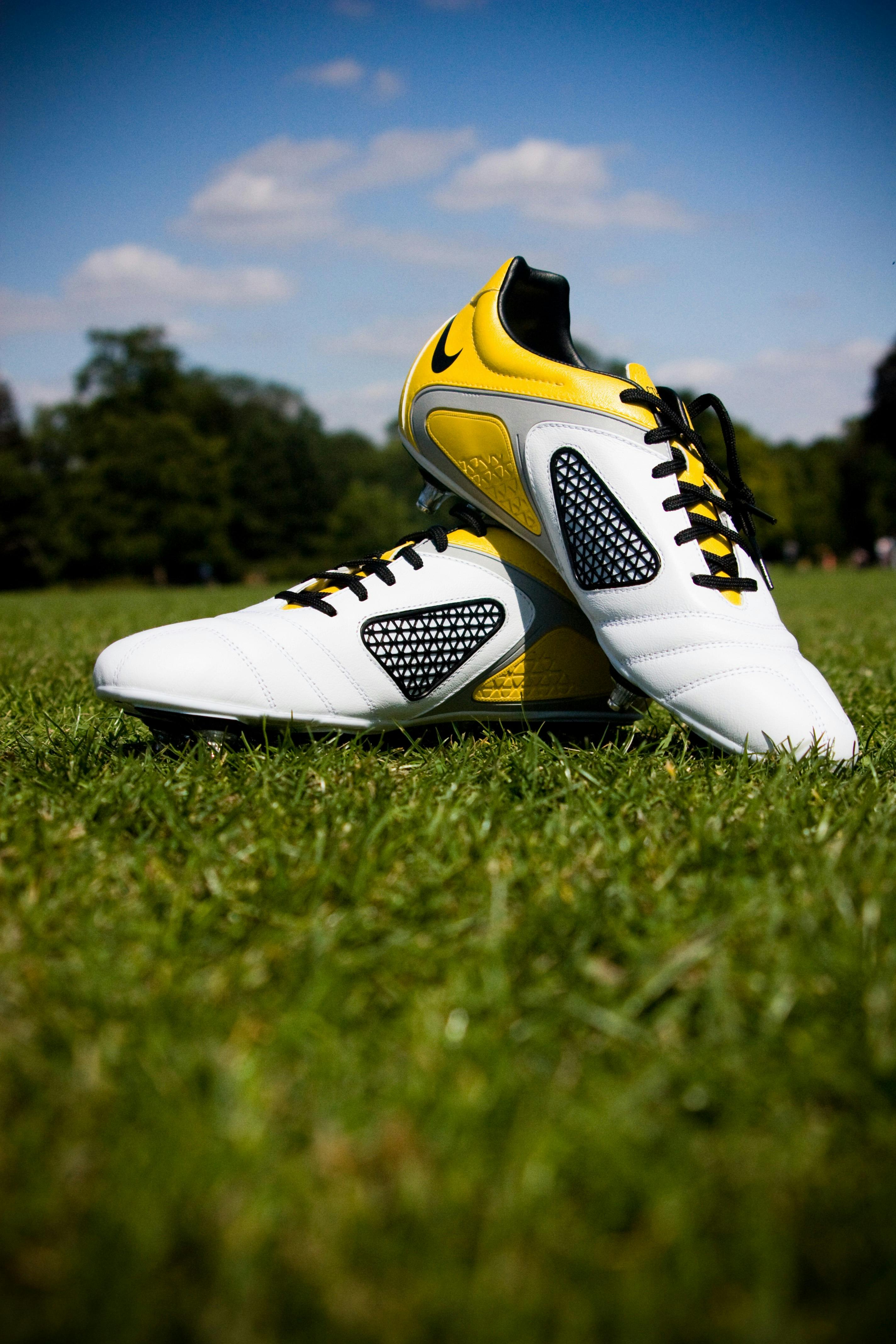 Pair of White-and-yellow Nike Cleats