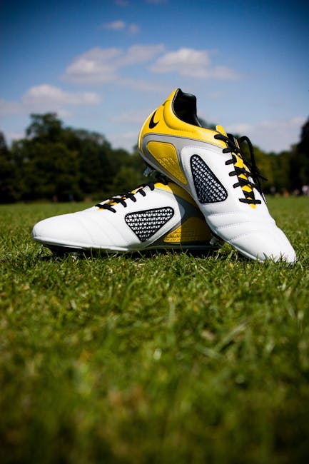 Pair of White-and-yellow Nike Cleats