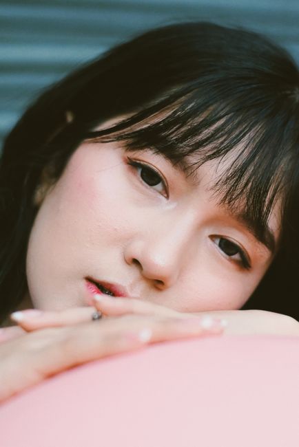 Soft close-up portrait of a young woman with a calm expression, highlighting beauty and relaxation.