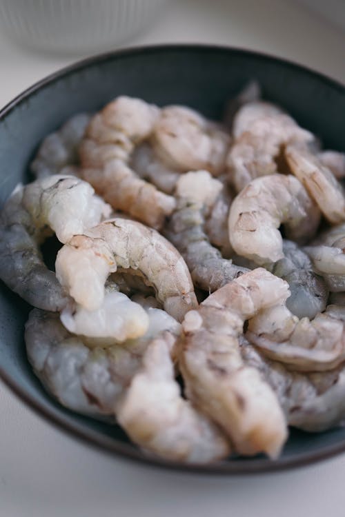 A bowl of shrimp sitting on a table