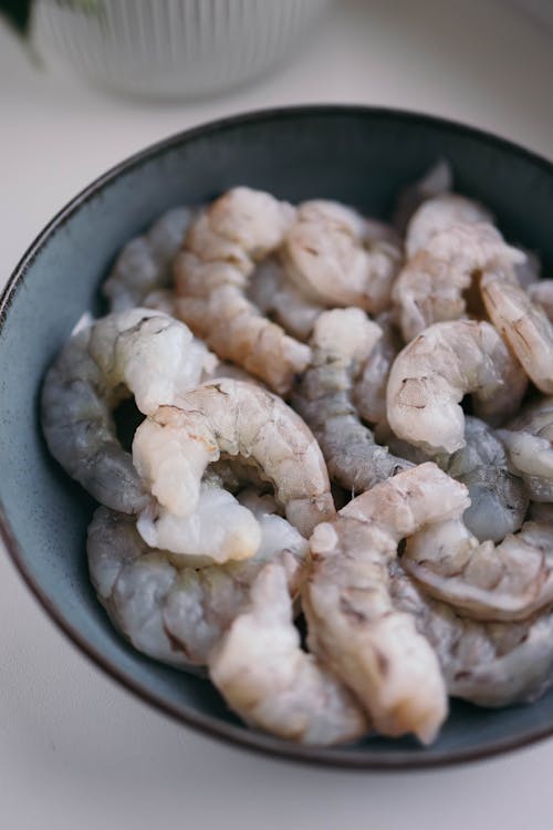 A bowl of shrimp sitting on a table
