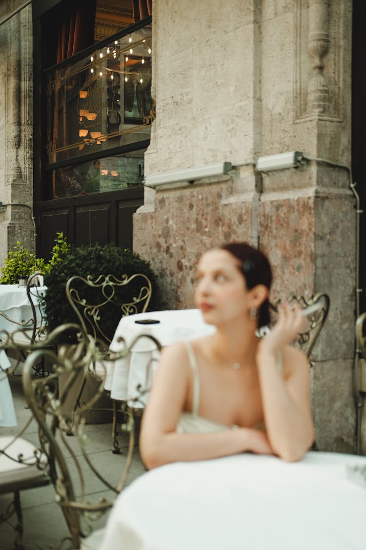 Woman Sitting At Cafe