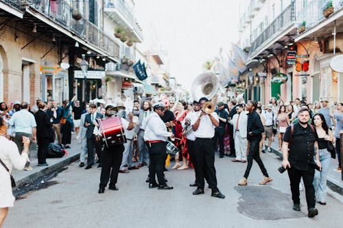 People Watching Musicians Playing at a Street Festivity in New Orleans, USA