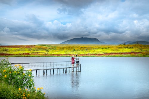 Two Persons Standing on Sea Dock