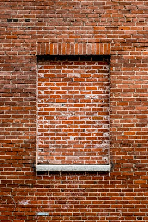 A brick wall with a window in it
