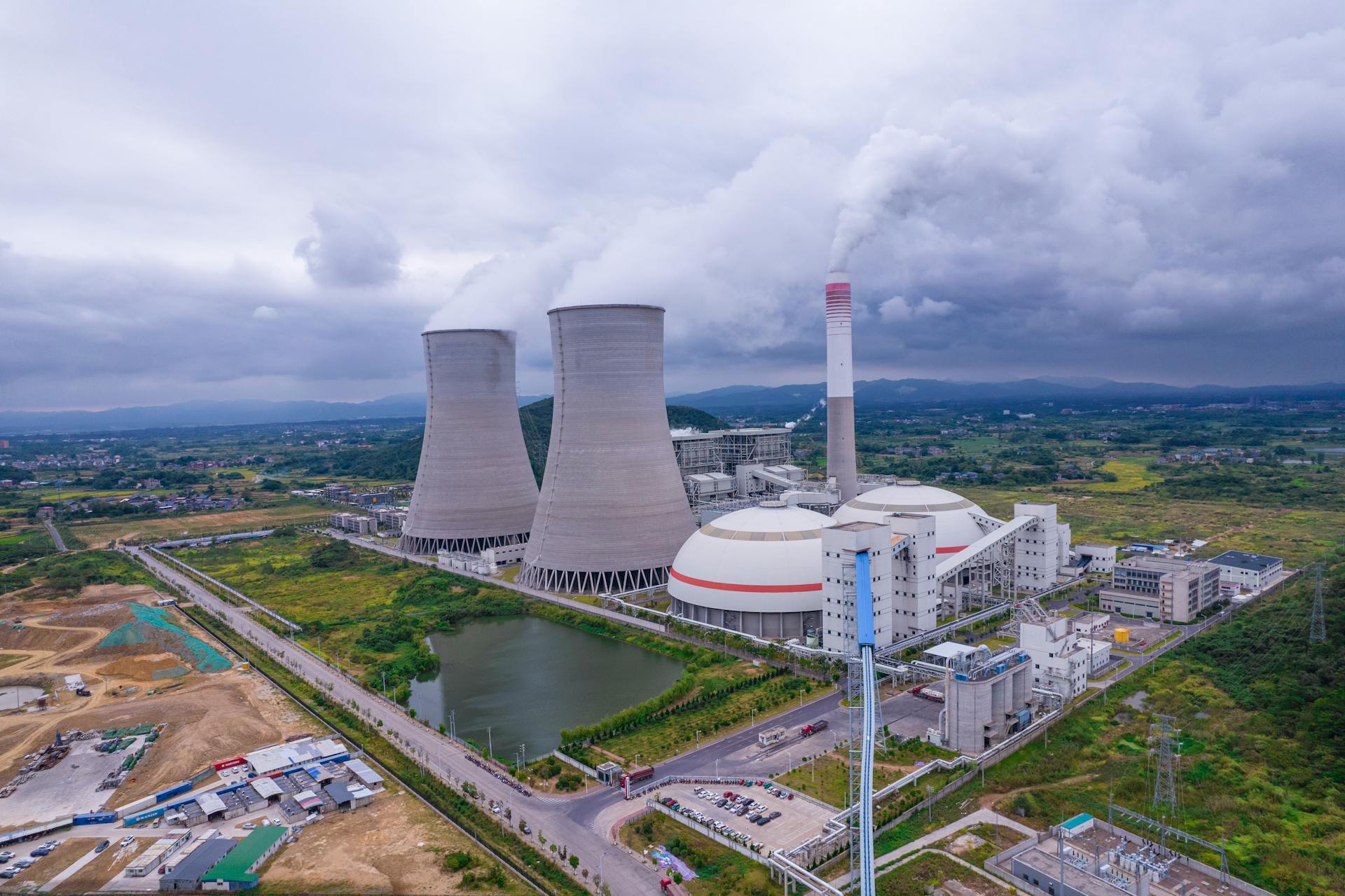 Aerial shot of a nuclear power plant in Jiangxi, China, with cooling towers and surrounding landscape.