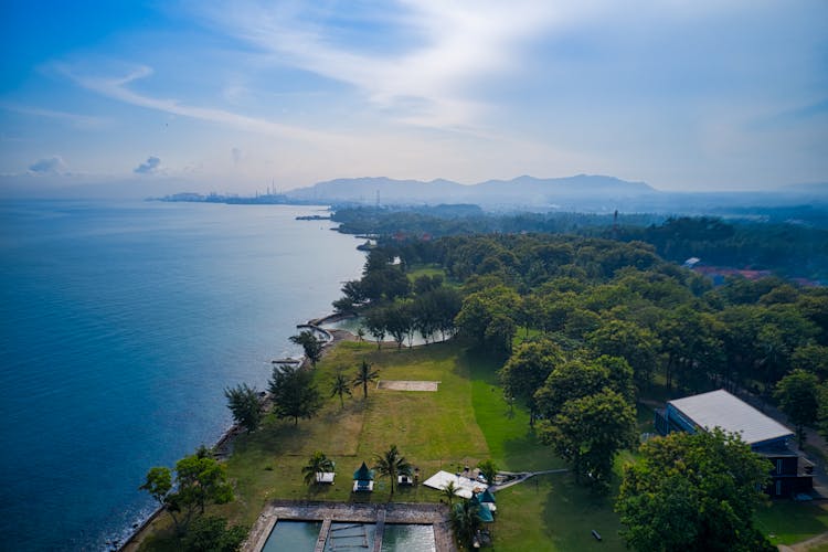 Aerial Photography Of House Near Body Of Water