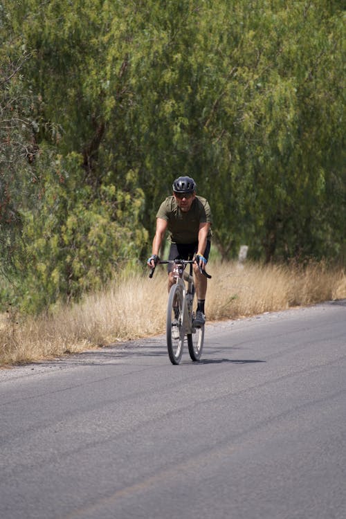 A man riding a bike down a road