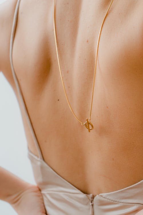 Golden Necklace on Woman Back