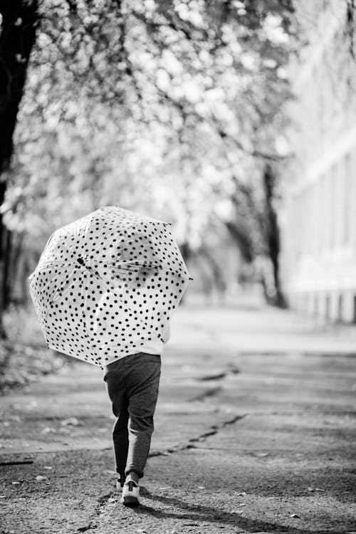 Girl Walking with Umbrella in Black and White