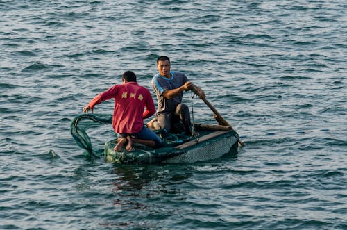 Two Man Riding Boat Photography