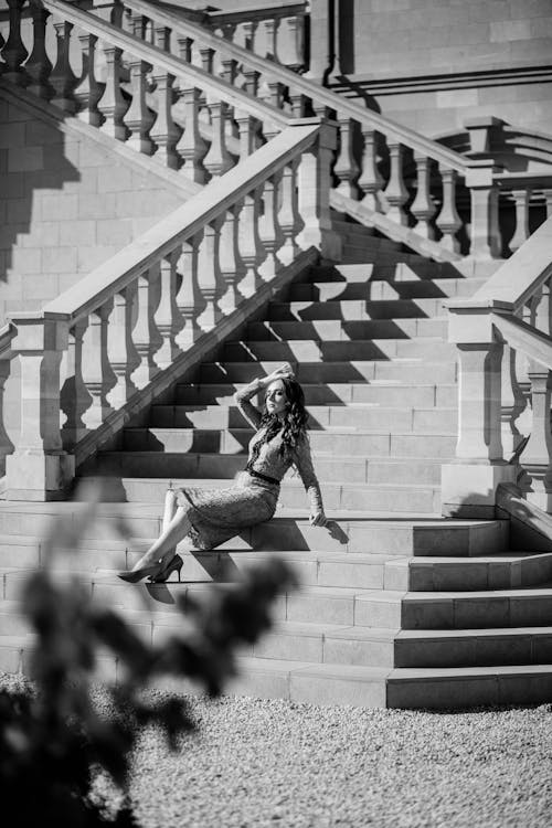 A woman sitting on the steps of a building