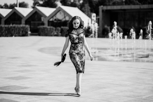 Woman Walking in Dress in Black and White