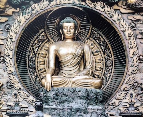 A buddha statue in a gold frame