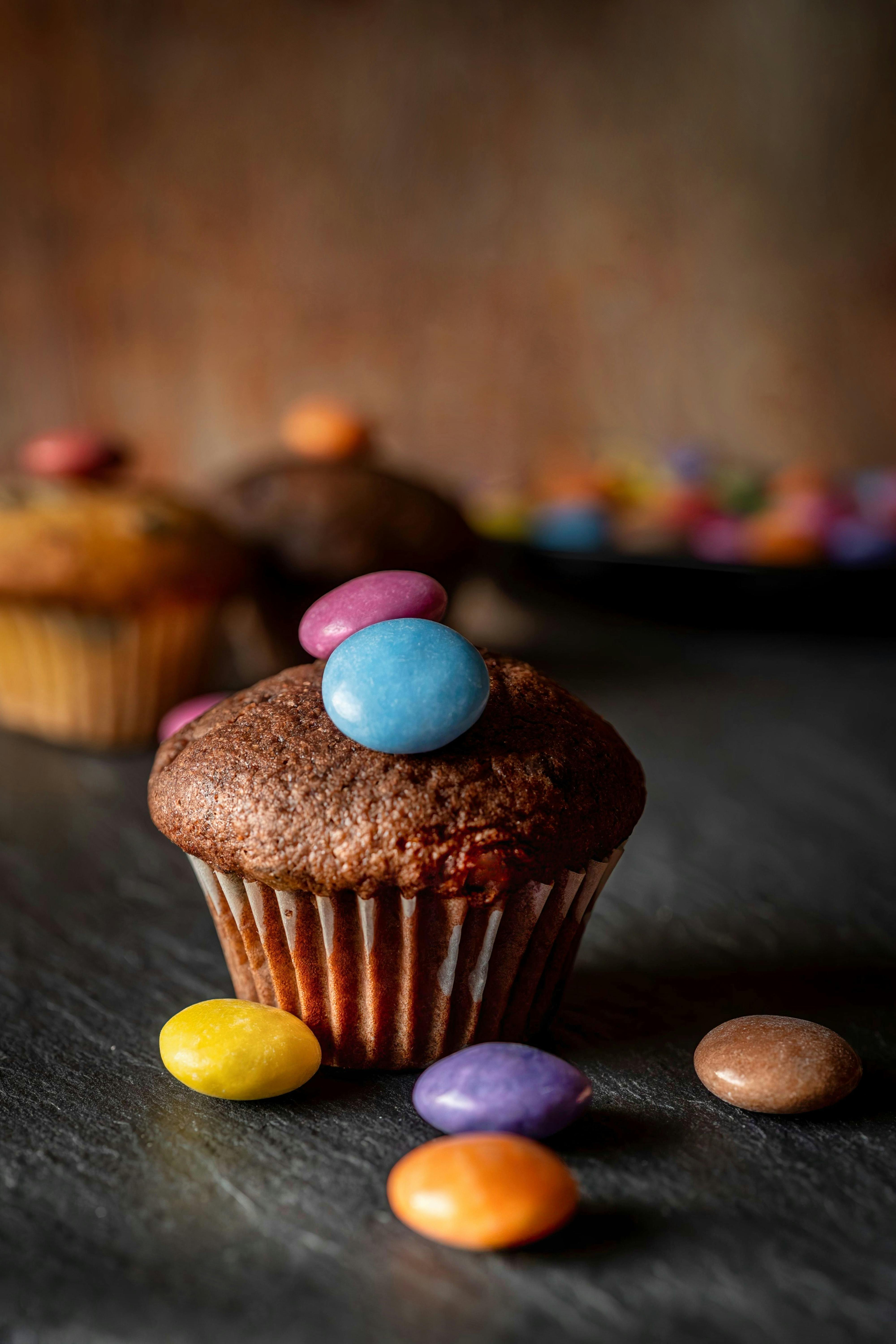 Delicious cupcake topped with colorful candies, perfect for dessert lovers and food enthusiasts.