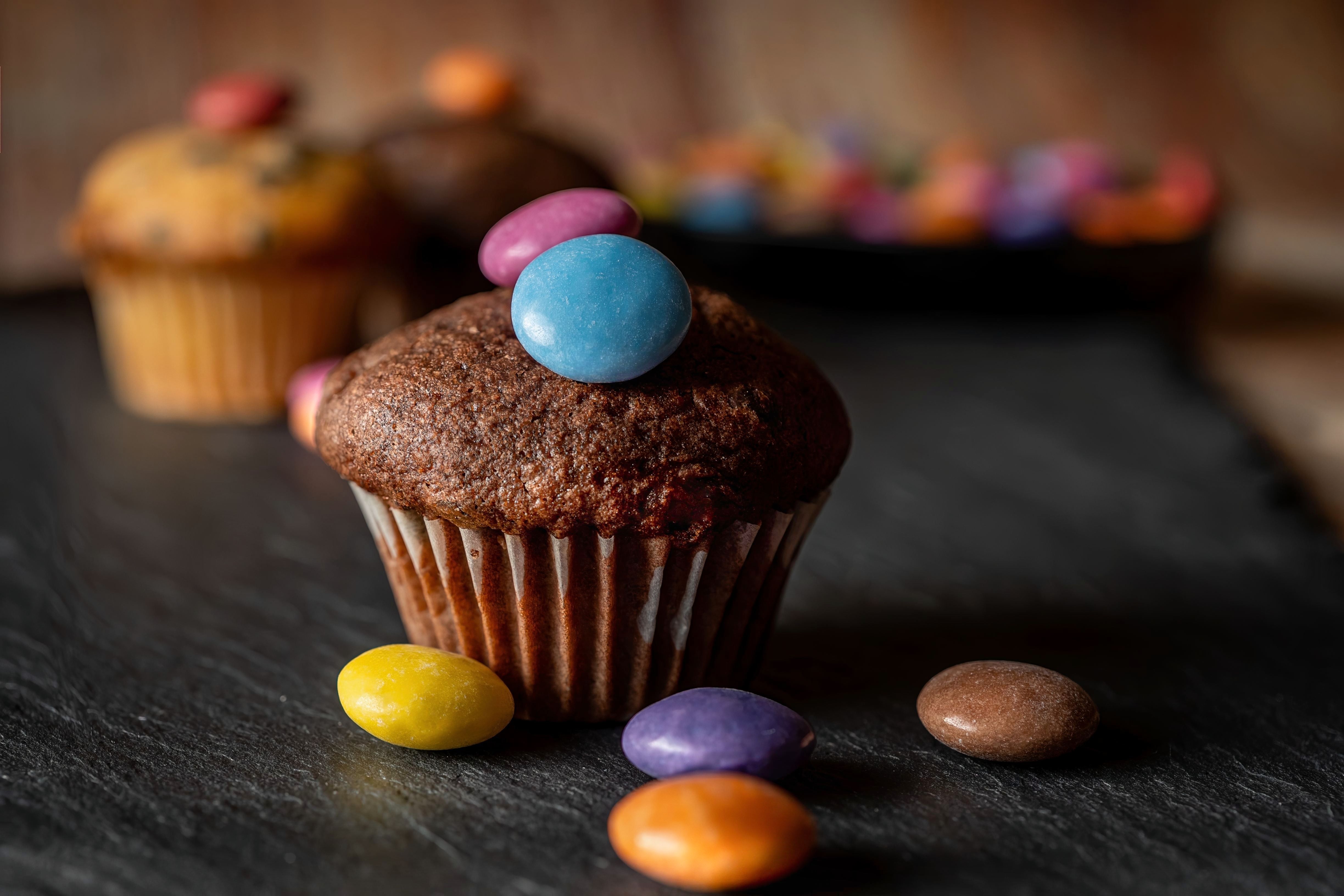 A delicious chocolate cupcake topped with colorful candies, perfect for sweet indulgence.