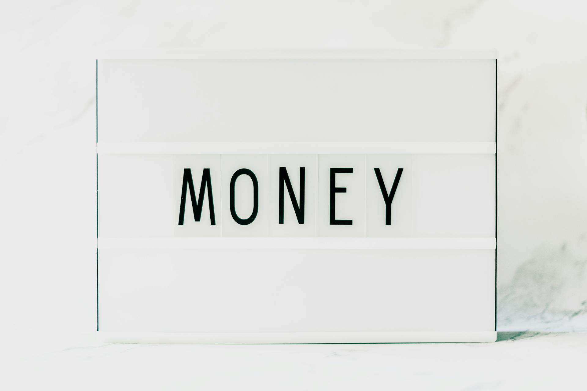 Close-up of a Light Box with a Word "Money" in the Middle