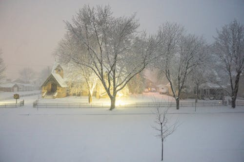 A snowy night with a church in the background